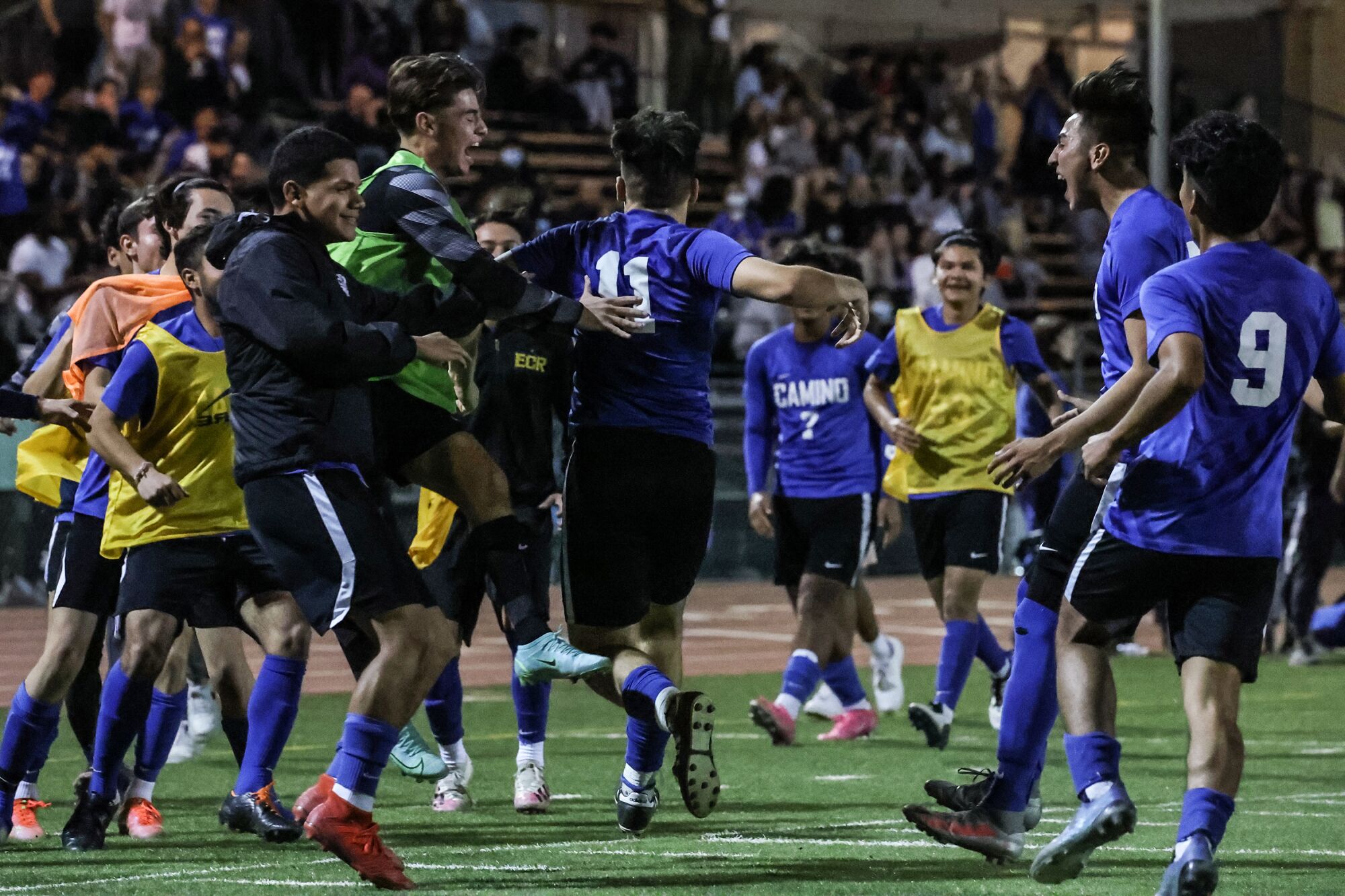 El Camino Real players celebrate following a successful penalty kick by teammate Julio Chacon.