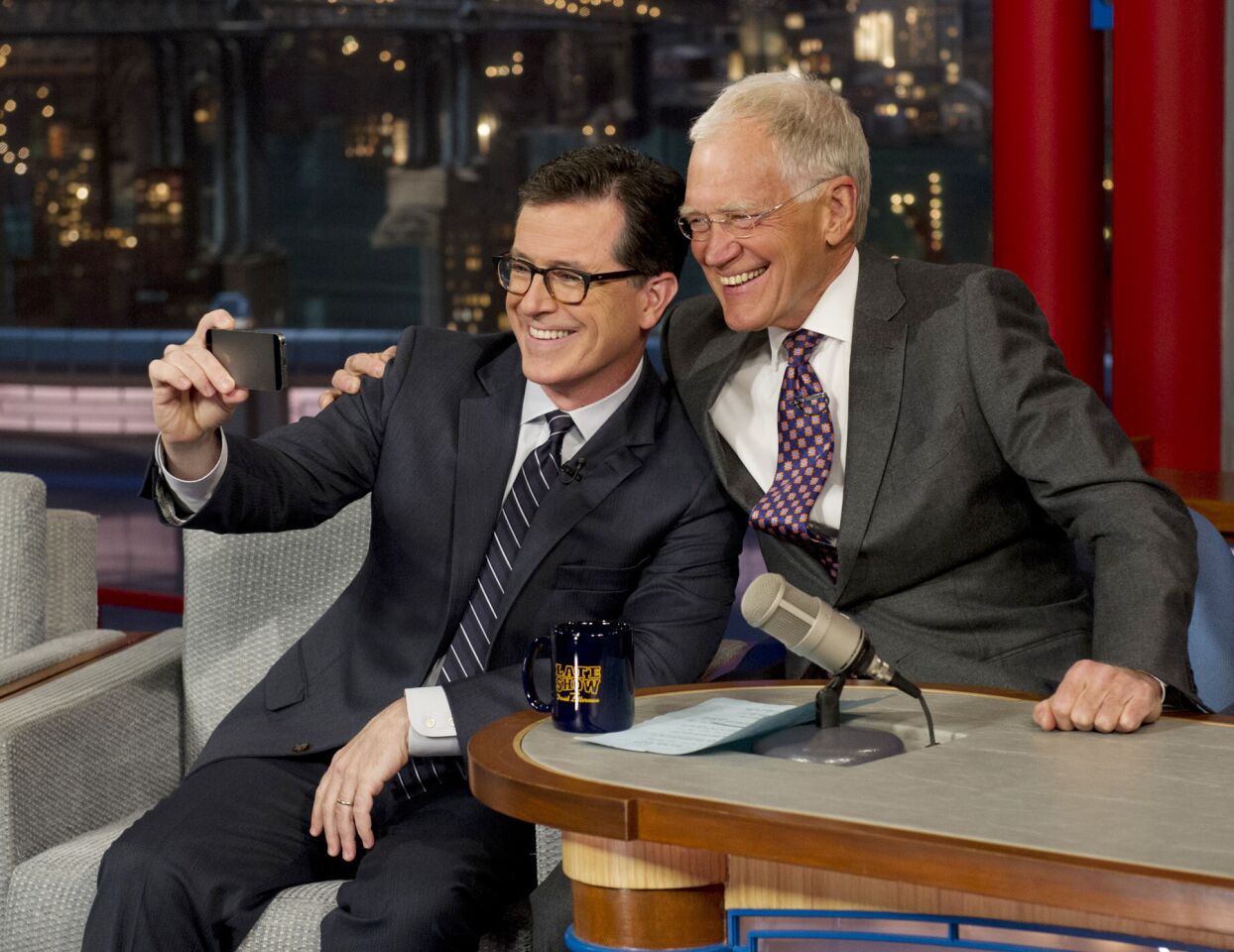 Stephen Colbert, left, takes a selfie with David Letterman on the set of "Late Show with David Letterman" on April 22, 2014, in New York. This was Colbert's first visit to the show since CBS announced that he will succeed Letterman as host when he retires in 2015.