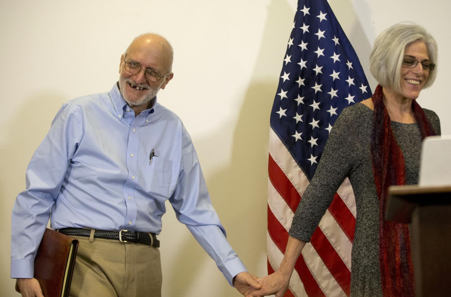 Alan Gross smiles as he walks in with his wife Judy before speaking to members of the media at his lawyer's office in Washington. Gross was released from Cuba after 5 years in a Cuban prison.