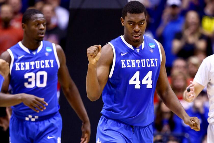 Kentucky center Dakari Johnson celebrates after scoring and being fouled in a Midwest Regional semifinal against Louisville on Friday night in Indianapolis.