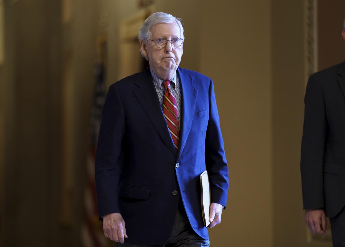 Senate Minority Leader Mitch McConnell, R-Ky., walks to the chamber as the Senate works to advance the $1 trillion bipartisan infrastructure bill, at the Capitol in Washington, Monday, Aug. 2, 2021. The 2,700-page bill includes new expenditures on roads, bridges, water pipes broadband and other projects, plus cyber security. (AP Photo/J. Scott Applewhite)