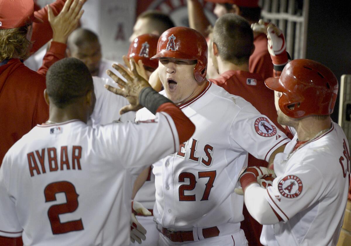 Mike Trout lets loose in the dugout after hitting a game-tying grand slam in the eighth inning Saturday against the Chicago White Sox.