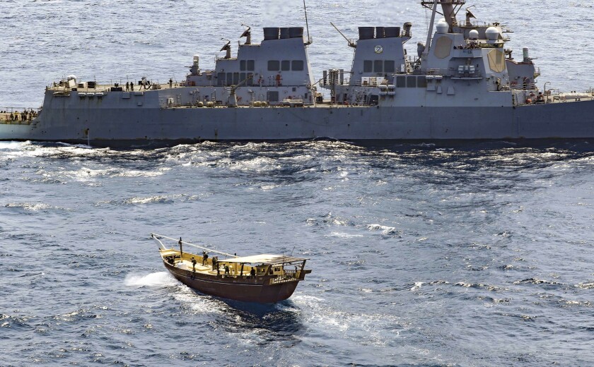 In this Friday, Feb. 12, 2021 photo released by the U.S. Navy, the guided-missile destroyer USS Winston S. Churchill boarded a stateless dhow off the coast of Somalia and interdicted an illicit shipment of weapons and weapon components. The U.S. Navy said on Tuesday, Feb. 16 that it seized a large cache of weapons, including Kalashnikov-style rifles and rocket-propelled grenade launchers, being smuggled by ships off the coast of Somalia. (Mass Communication Specialist 3rd Class Louis Thompson Staats IV/U.S. Navy via AP)