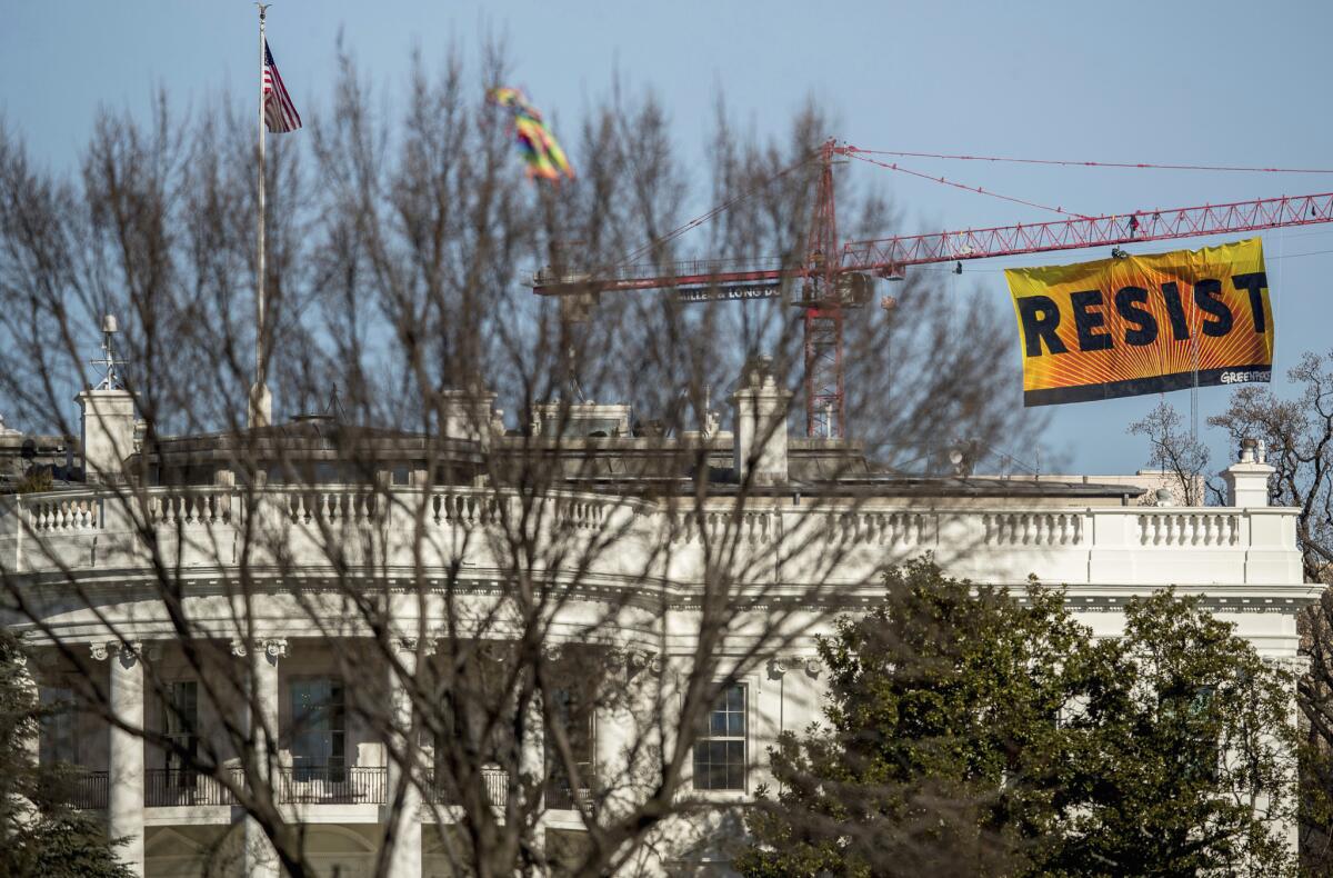 Greenpeace protesters unfurled a banner that read "Resist" at the construction site of the former Washington Post building, near the White House, on Wednesday.