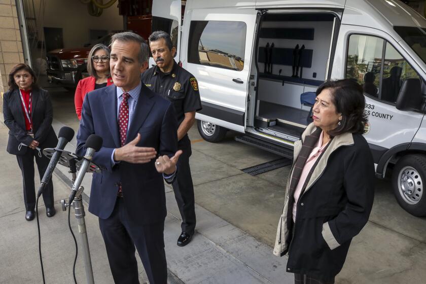 Los Angeles, CA - March 03: Mayor Eric Garcetti, flanked by deputy director department of mental health Miriam Brown, left, councilwoman Monica Rodriguez, LAFD chief Ralph Terrazas and supervisor Hilda Solis, introduces Therapeutic Van Pilot Program at a press conference held at LAFD Fire Station 4 on Thursday, March 3, 2022 in Los Angeles, CA. (Irfan Khan / Los Angeles Times)