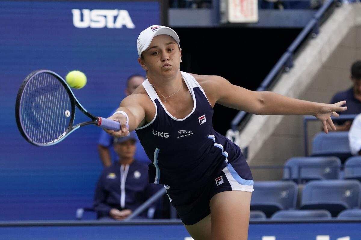 Top-seeded Ashleigh Barty returns a shot to Clara Tauson during the second round of the U.S. Open on Thursday in New York.