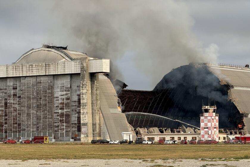 TUSTIN CA NOVEMBER 7, 2023 - A massive fire continues to burn the historic north blimp hangar in Tustin, an Orange County landmark that dates back to World War II on Tuesday morning, Nov. 7, 2023. (Irfan Khan / Los Angeles Times)