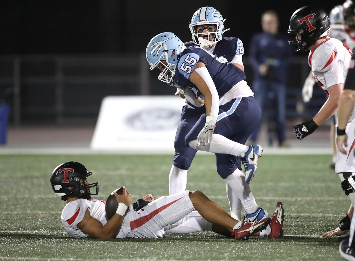 Corona del Mar lineman Damian Zeno-Herrera (55) sacks San Clemente quarterback Dawson Martinez on Friday night.