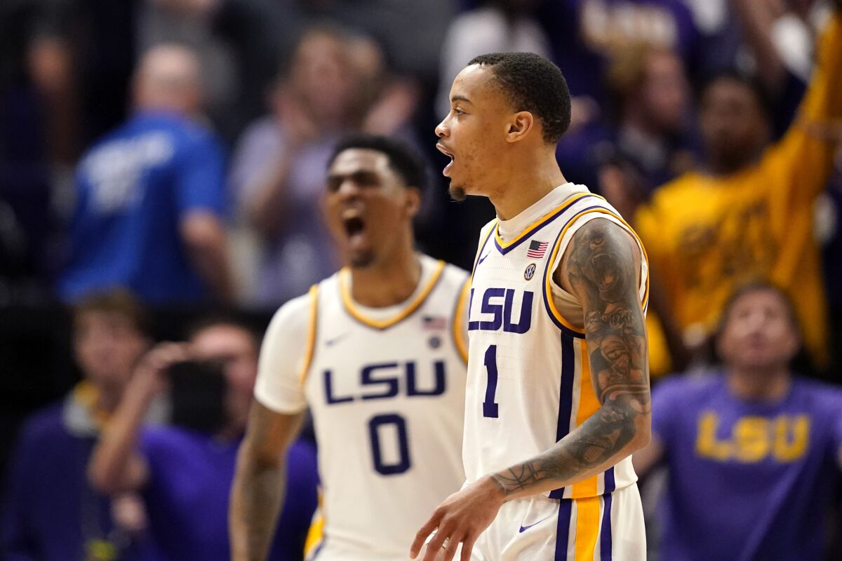 LSU guard Xavier Pinson (1) and guard Brandon Murray (0) react after defeating Alabama in overtime of an NCAA college basketball game in Baton Rouge, La., Saturday, March 5, 2022. LSU won 80-77. (AP Photo/Gerald Herbert)