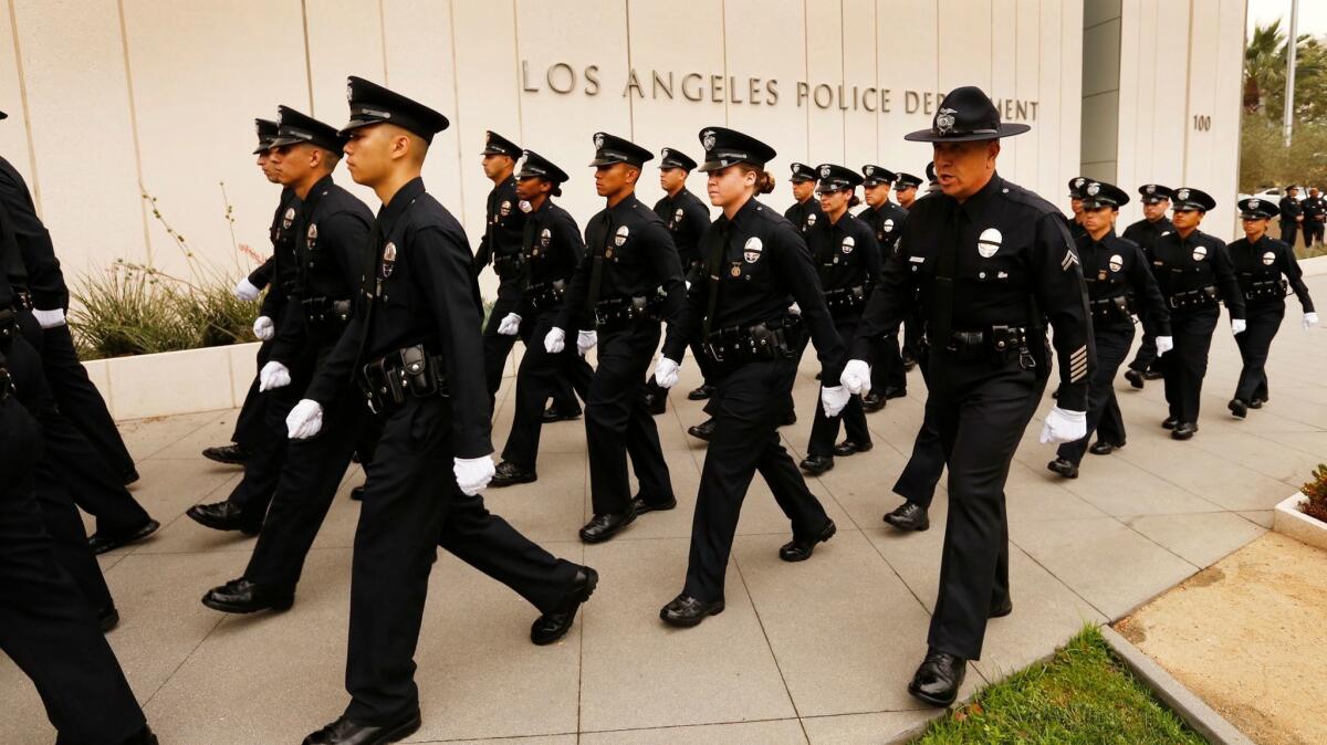 New Los Angeles police officers walk into a graduation ceremony in 2016.