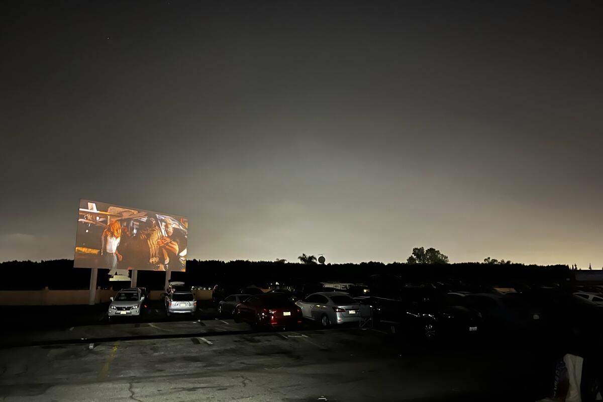 Visitors enjoy a screening of "Jurassic World: Dominion" at the Paramount Drive-In Theater.