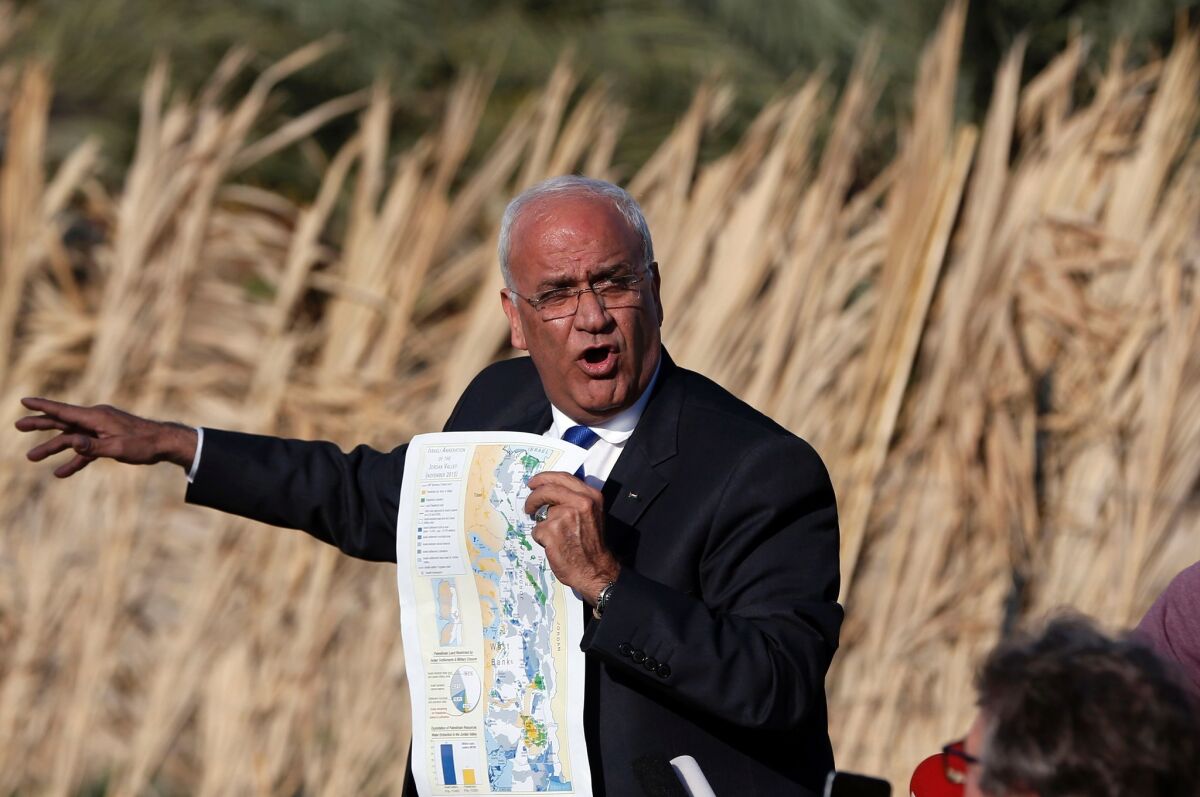 Saeb Erekat, a Palestinian diplomat, shows a map as he addresses journalists Jan. 20 in the West Bank city of Jericho about Israel's plans for more Jewish settlements.