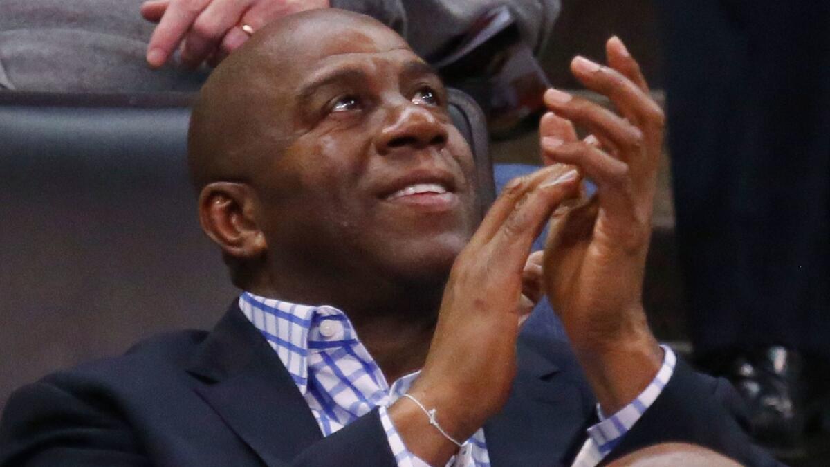 Magic Johnson watched Sunday's Lakers game at Staples Center from a suite, but on Friday in Oklahoma City, above, he watched the game from the seats.
