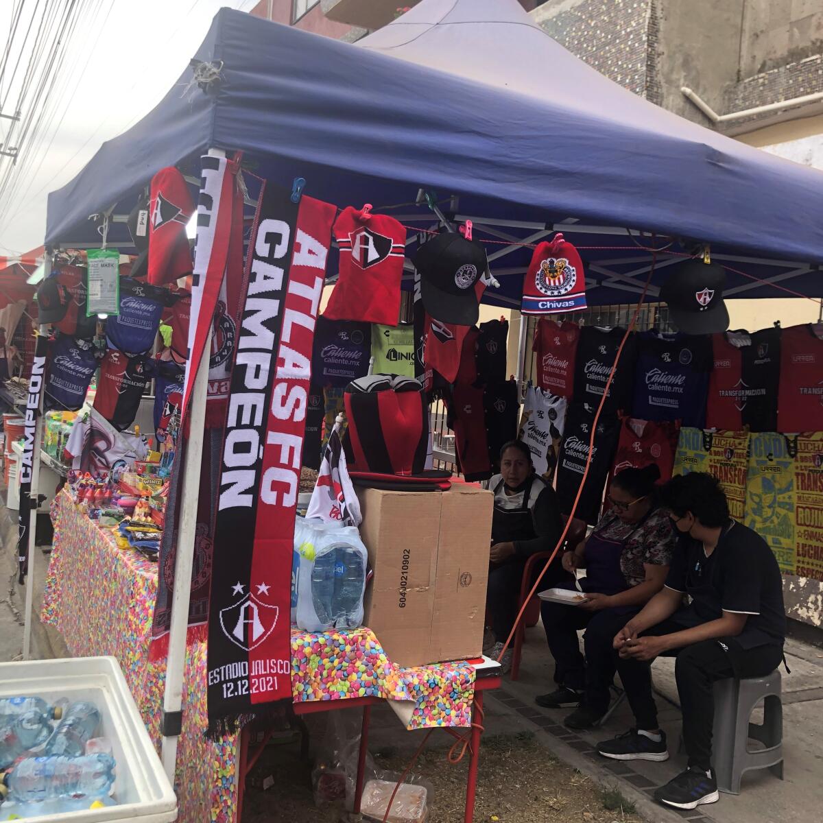 Vendors sell Atlas FC 2021 championship merchandise near Estadio Jalisco in Guadalajara Mexico.