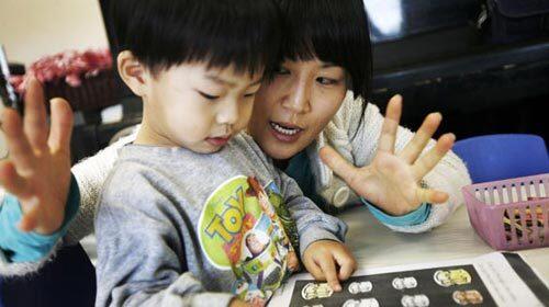 Teacher Suhee Yun helps Stephen Chung, 3, with a lesson in a class of children 3 or 4 years old in Porter Ranch in the San Fernando Valley. The Valley has emerged as a significant population center for Korean Americans in Southern California.