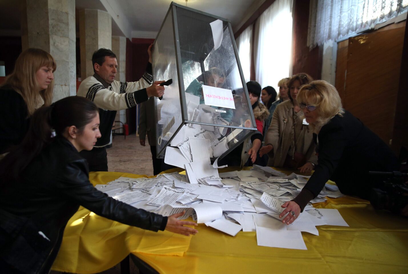 Poll workers in Slovyansk, Ukraine, dump a ballot box to count votes after heavily Russian communities in eastern Ukraine staged a sovereignty referendum.