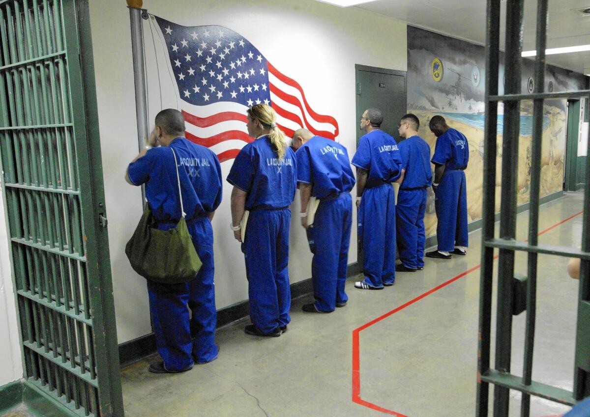 Inmates wait to be transferred into one of the module housing areas at the Men's Central Jail in downtown Los Angeles. On Friday, federal judges gave the state until Dec. 1 to finish plans for a parole program and ordered it in place by January to ease overcrowding in jails.