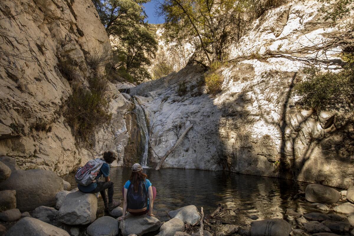 Two hikers enjoy a view at lower Switzer Falls.