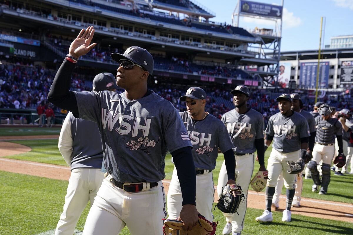 Washington Nationals' Juan Soto, left, celebrates with his teammates after a baseball game against the New York Mets at Nationals Park, Sunday, April 10, 2022, in Washington. The Nationals won 4-2. (AP Photo/Alex Brandon)