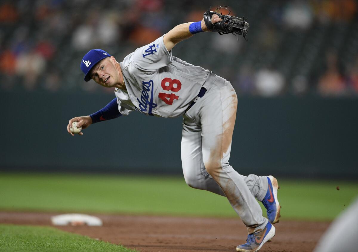 Dodgers second baseman Gavin Lux looks to throw to first base during a game against the Baltimore Orioles in September.