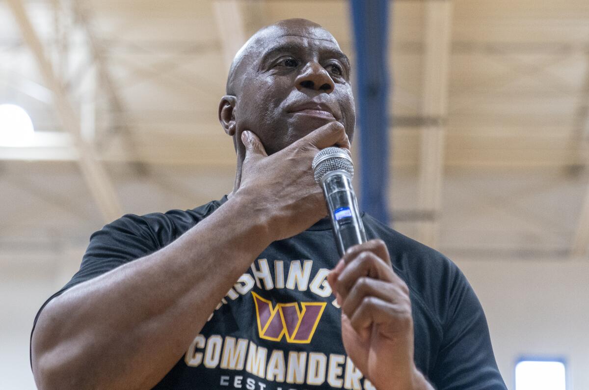 Washington Commanders part-owner Magic Johnson pauses while speaking at the Boys & Girls Club of Greater Washington