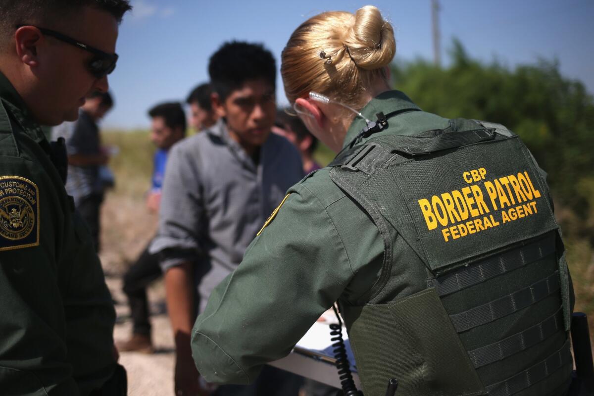 U.S. Border Patrol agents detain immigrants caught crossing the border from Mexico into the United States in August near McAllen, Texas. A federal agency is recommending that border agents not wear body cameras.
