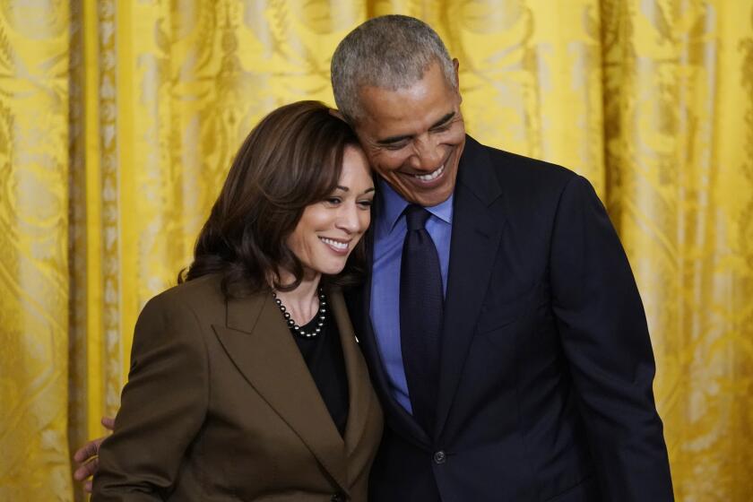 Vice President Kamala Harris and former President Barack Obama embrace on stage during an event about the Affordable Care Act in the East Room of the White House in Washington, Tuesday, April 5, 2022. (AP Photo/Carolyn Kaster)