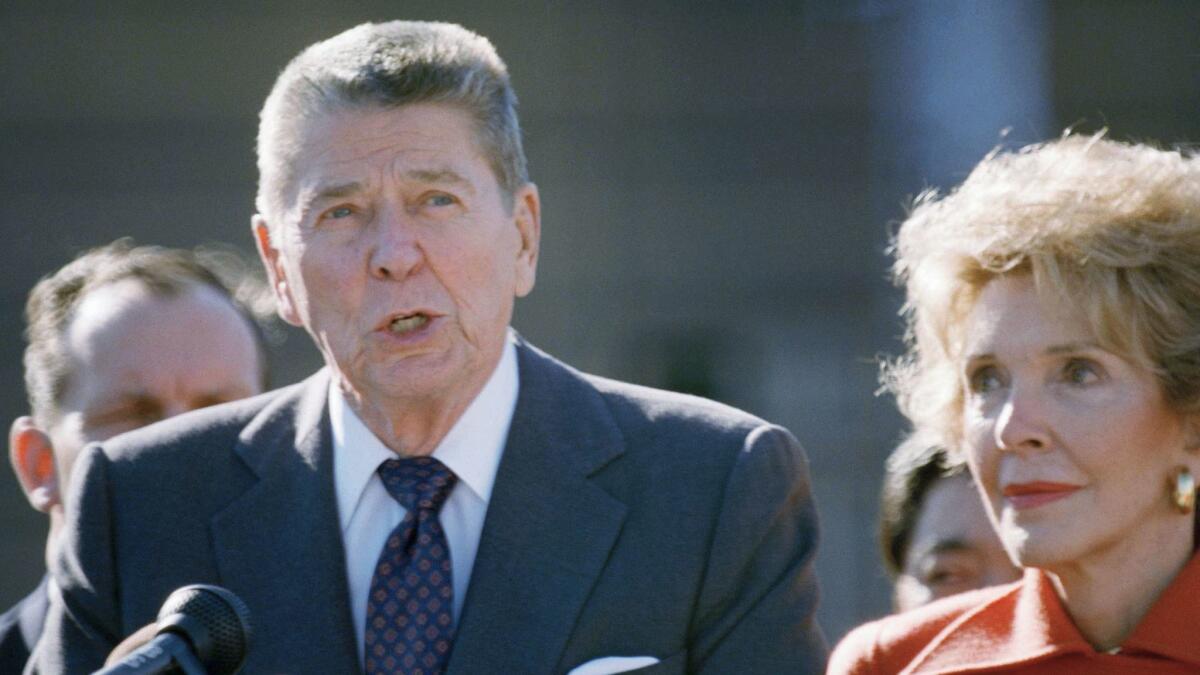 Former U.S. President Ronald Reagan, left, delivers a speech as his wife Nancy stands beside him, upon their arrival at Tokyo?s Haneda International Airport, Friday, Oct. 20, 1989, Tokyo, Japan. The former first couple were invited by a Japanese media conglomerate, which is reportedly spending one billion yen (7 million U.S. dollars) for their nine-day ?official and private? visit to Japan. (AP Photo/Katsumi Kasahara)