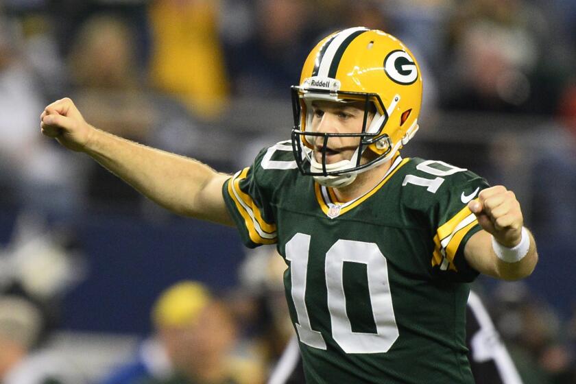 Matt Flynn, then quarterback for the Green Bay Packers, celebrates a touchdown against the Dallas Cowboys in December 2013. On Friday, Flynn signed with the New England Patriots.