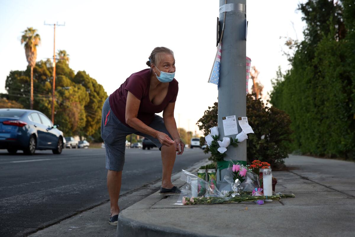 Blanca Hernandez adds to a memorial for Sylvia Maglia