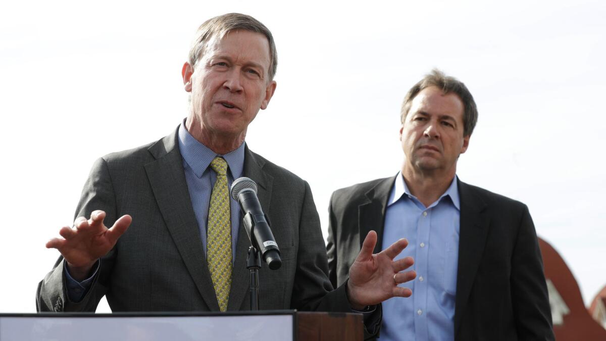 Colorado Gov. John Hickenlooper, left, with Montana Gov. Steve Bullock at a meeting of the Western Governors' Assn. in Coronado, Calif., on Tuesday.