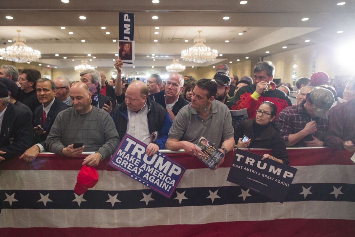 Supporters of Republican presidential candidate Donald Trump wait for him after a Town Hall in Nashua, N.H. on Jan. 29.