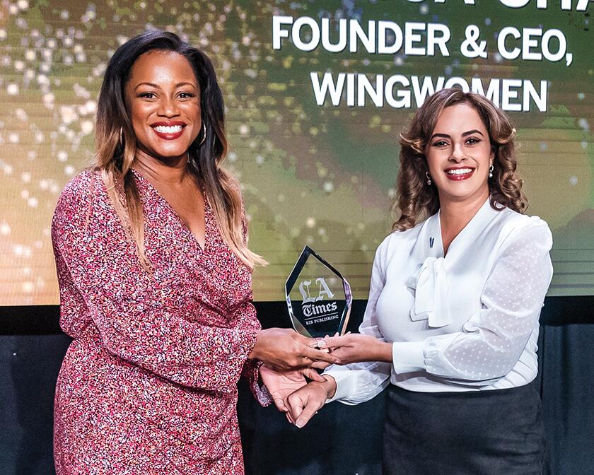 Adonica Shaw (Wingwomen) receives an award from Sharon Alexander (City National Bank).