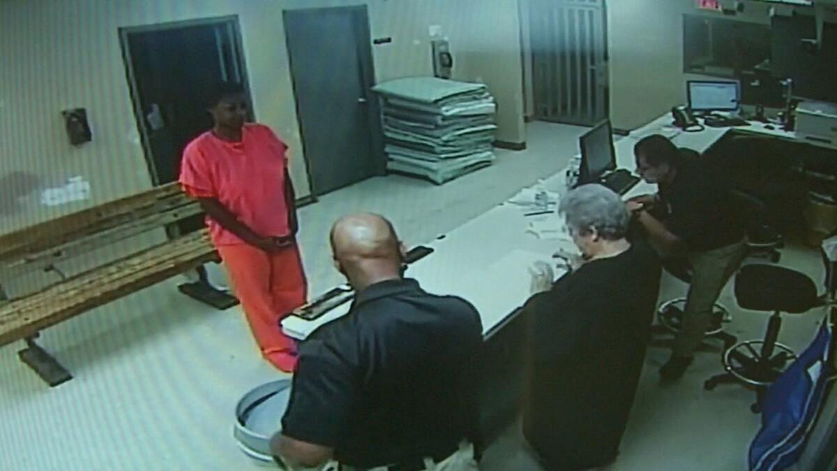 In this undated file frame from video provided by the Waller County Sheriff's Department, Sandra Bland stands before a desk at Waller County Jail in Hempstead, Texas.