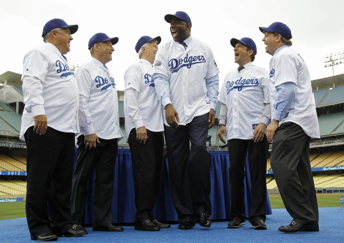 The Guggenheim Baseball Management group, which purchased the Dodgers in 2012, pose for photos during a news conference at Dodger Stadium on May 2, 2012.