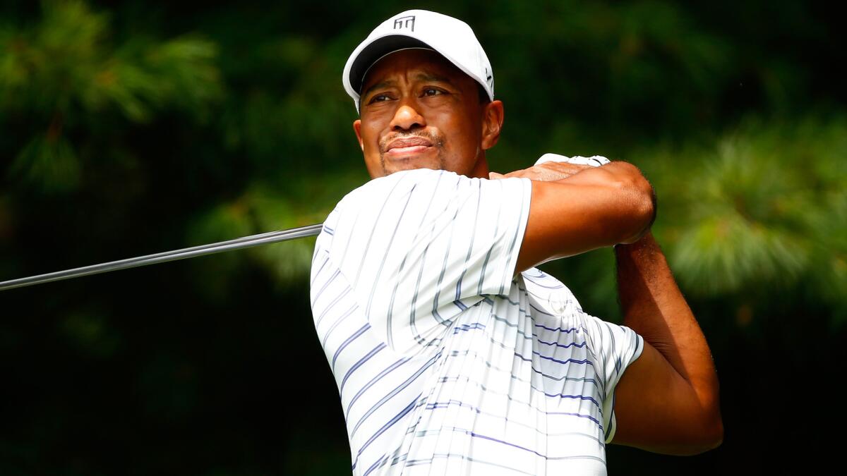 Tiger Woods plays a shot during a practice round Wednesday in preparation for this week's Bridgestone Invitational at Firestone Country Club in Akron, Ohio.