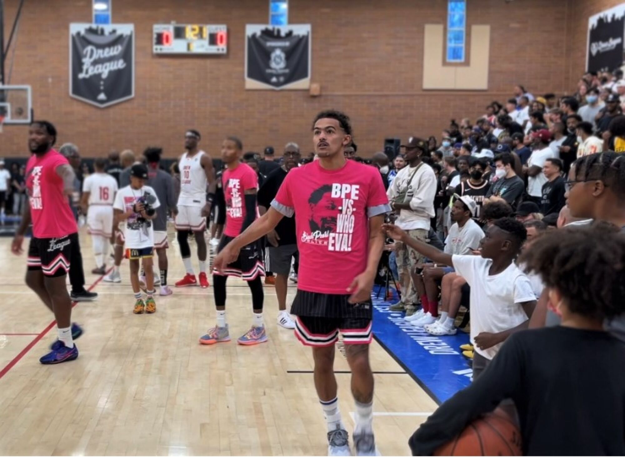 Hawks All-Star guard Trae Young warms up with Black Pearl Elite teammates for a Drew League game  Saturday.