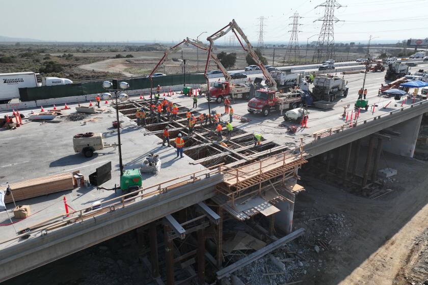 Work crews with the California Department of Transportation working on a renovation project on the 210 Freeway.