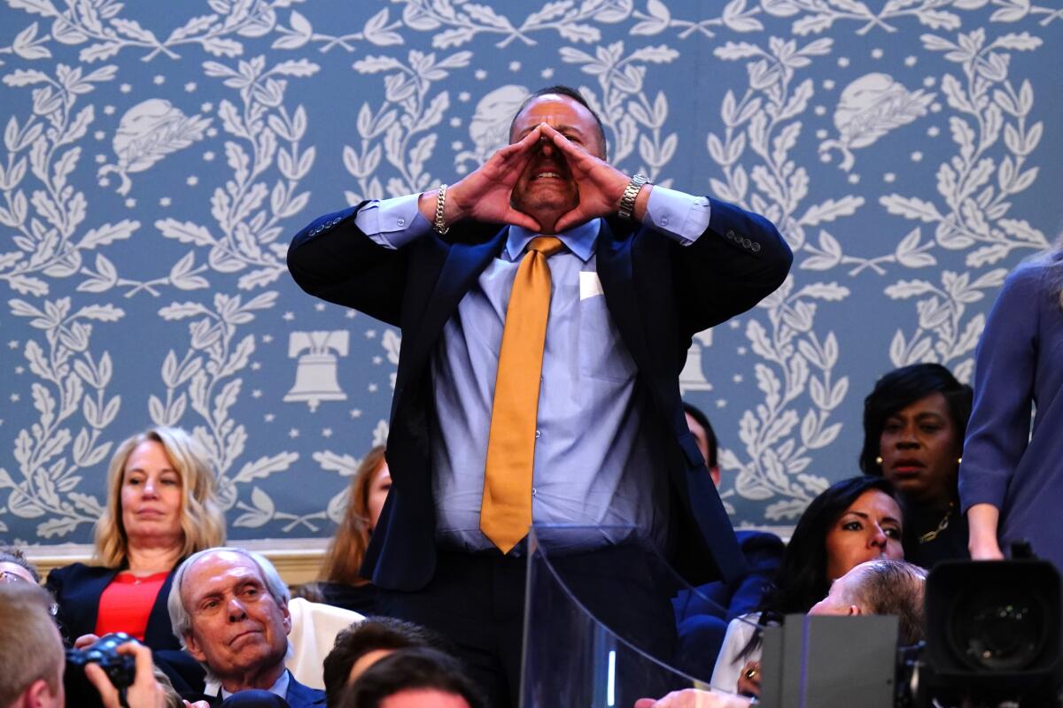 A demonstrator shouts during a State of the Union address at the US Capitol in Washington, DC, US, on March 7, 2024.