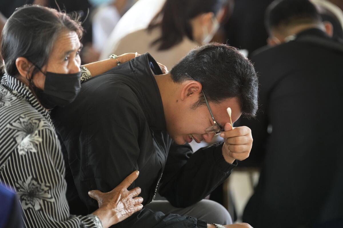 Woman comforting grieving young man