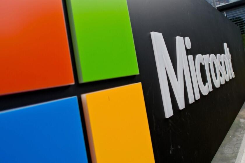 epa04863560 The Microsoft logo outside the software company's German headquarters in Unterschleissheim, Germany, 28 July 2015. Microsoft will launch its new and much anticipated operating system Windows 10 on 29 July 2015. EPA/SVEN HOPPE ** Usable by LA, CT and MoD ONLY **