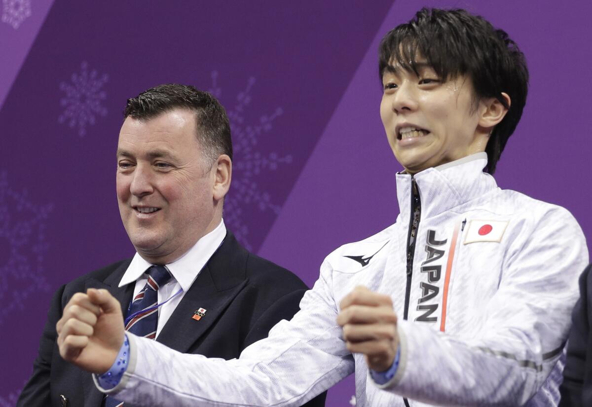 Yuzuru Hanyu of Japan reacts as his score is posted following his performance in the men's short program figure skating.