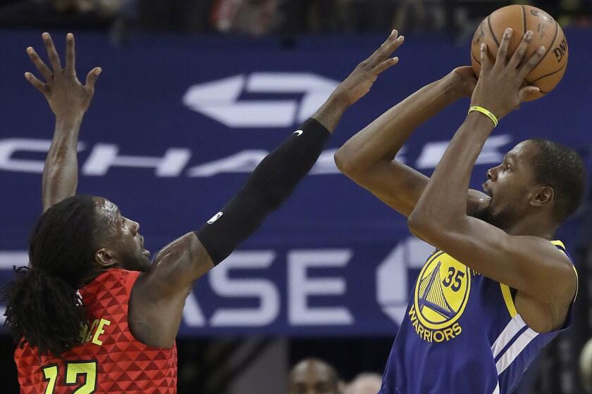 Golden State Warriors forward Kevin Durant (35) shoots against Atlanta Hawks forward Taurean Prince (12) during the first half of an NBA basketball game in Oakland, Calif., Tuesday, Nov. 13, 2018. (AP Photo/Jeff Chiu)