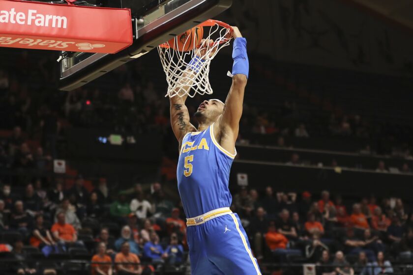UCLA guard Amari Bailey (5) dunks against Oregon State.