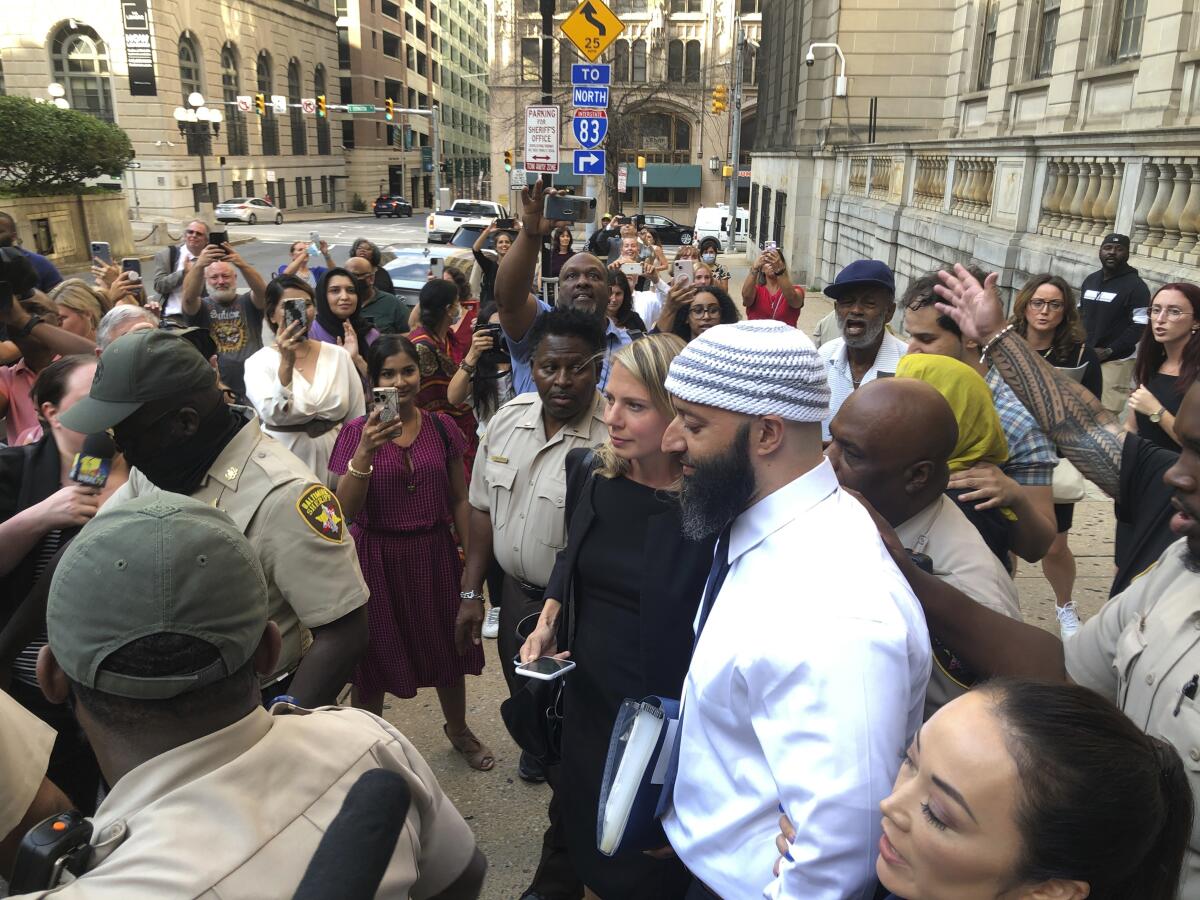 Adnan Syed, center, leaves the Cummings Courthouse