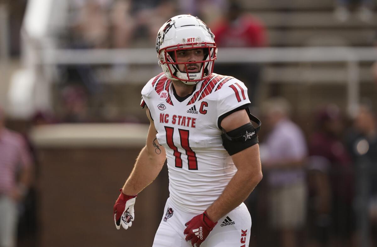 FILE - North Carolina State linebacker Payton Wilson (11) runs during warmups prior to their NCAA college football game against Mississippi State in Starkville, Miss., Saturday, Sept. 11, 2021. NC State begins its season Sept. 3, 2022, against East Carolina. (AP Photo/Rogelio V. Solis, File)