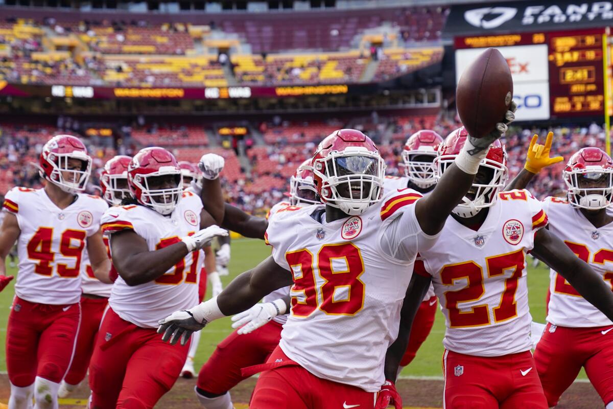 Kansas City Chiefs defensive end Tershawn Wharton (98) holds up the football as he celebration his interception against the Washington Football Team during the second half of an NFL football game, Sunday, Oct. 17, 2021, in Landover, Md. Chiefs won 31-13. (AP Photo/Alex Brandon)