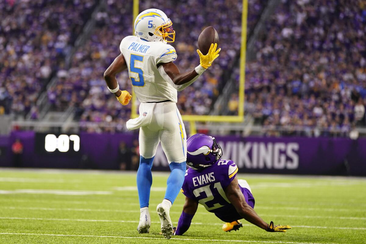 The Chargers' Joshua Palmer (5) makes the deciding a 30-yard touchdown catch against the Vikings. 
