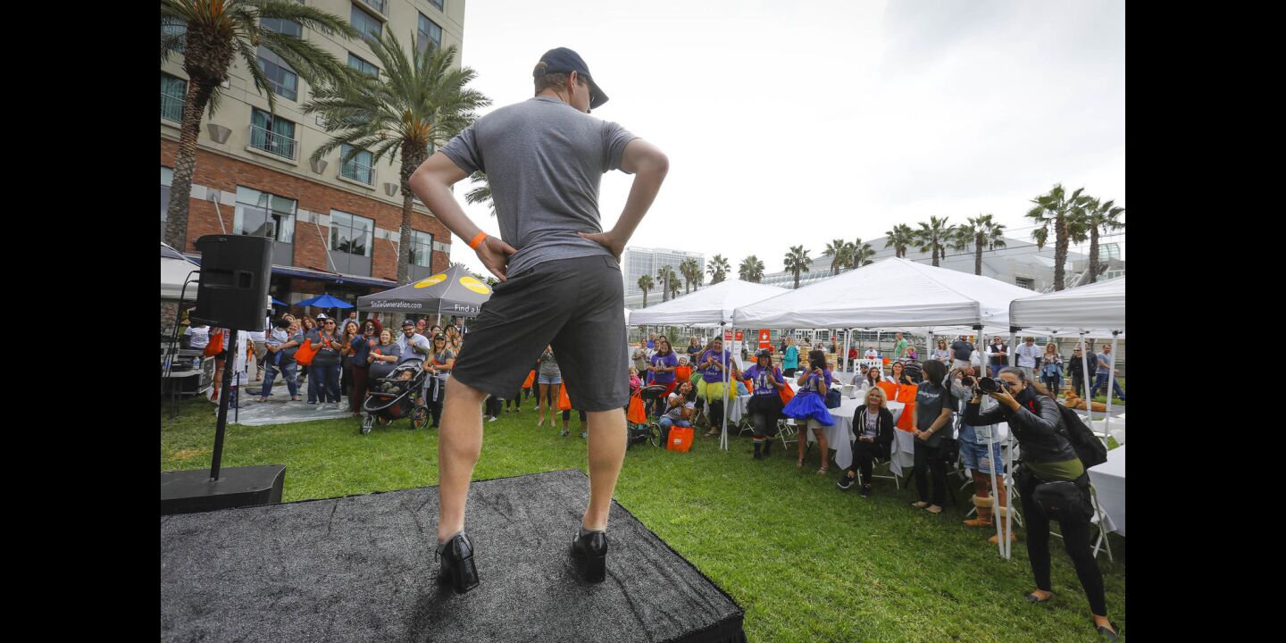 Austin Andrews of Pacific Beach was one of a couple of hundred people to walk through the Gaslamp Quarter during the YWCA'S 11th annual "Walk a Mile in Her Shoes," taking a stand against domestic violence.