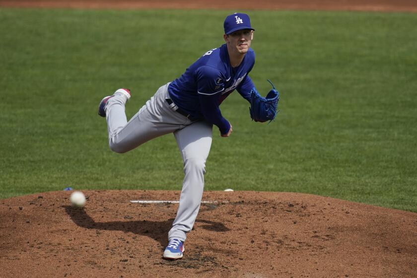 Los Angeles Dodgers starting pitcher Walker Buehler throws against the Cleveland Indians.